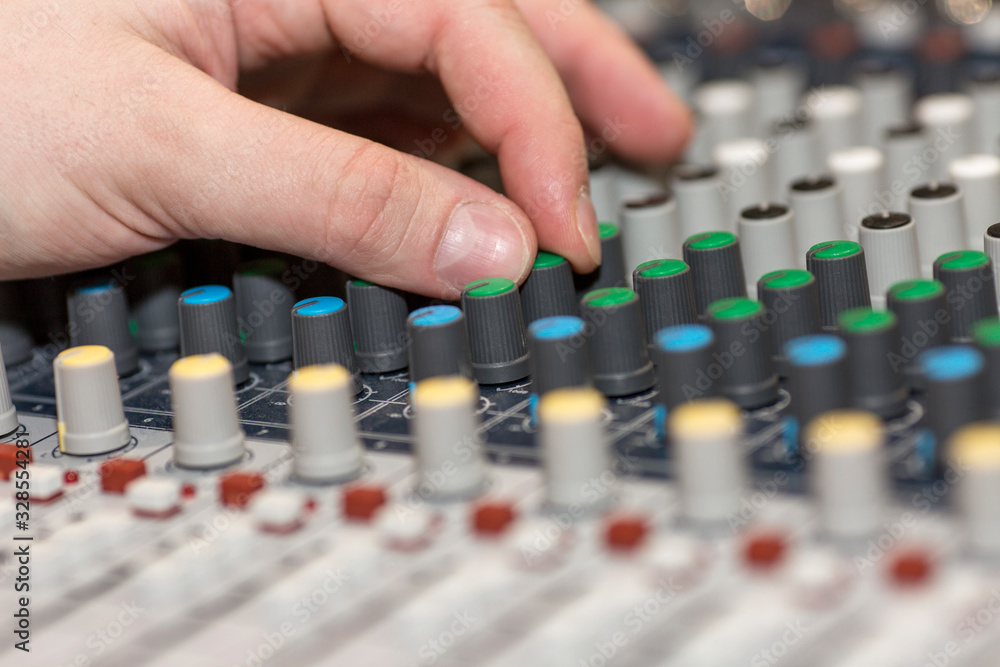 Sound mixer. Close-up. The hand on the remote controls. Sound mixer. Close-up. The hand on the remote controls.