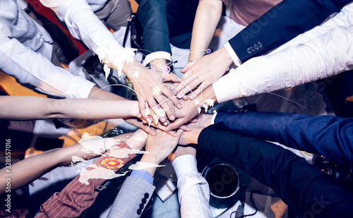Wallpaper Mural Teamwork, unity concept, people putting their hands together, top view.  Torontodigital.ca