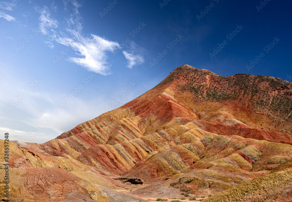 Rainbow mountains with blue sky in China at Zhangye Danxia geological park. Colorful rock formations with geological layers in the Gobi desert.