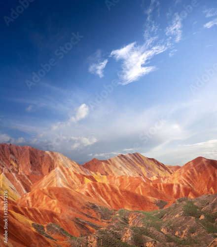 Rainbow mountains with blue sky in China at Zhangye Danxia geological park. Colorful rock formations with geological layers in the Gobi desert.