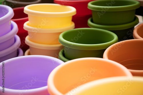 Many beautiful multi-colored flower pots. Close-up