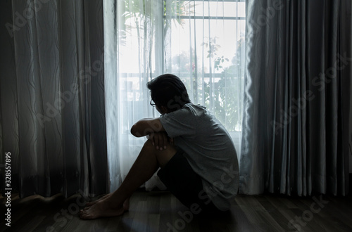Sad young woman sitting in the bedroom, People with depression concept.	
