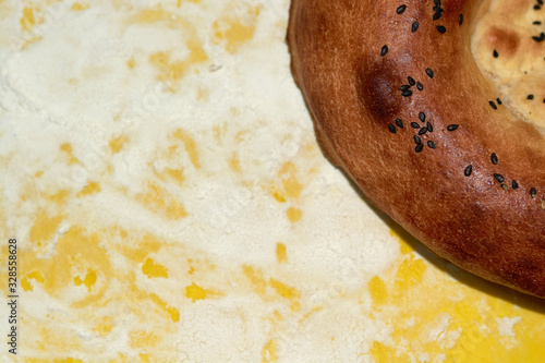 Oriental flatbread with sesame seeds on a yellow background with white flour photo