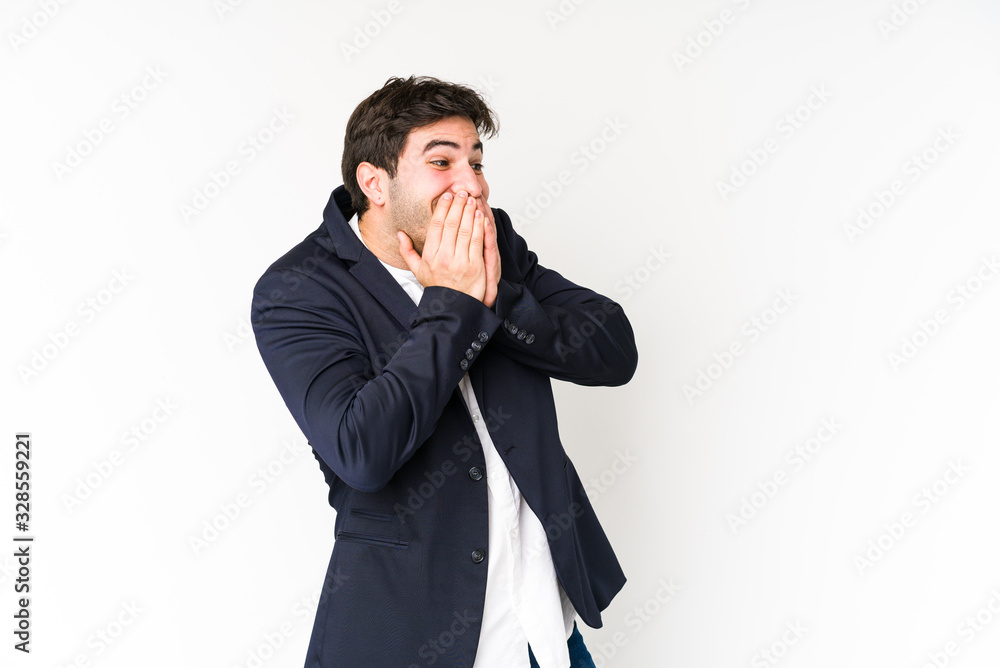 Young business man isolated on white background laughing about something, covering mouth with hands. Young business man isolated on white background laughing about something, covering mouth with hands.