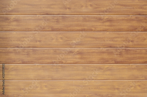 Horizontal wooden planks of brown color as a background.