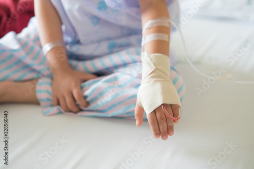 hand of Little girl was sick in hospital room,selective focus 