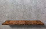 Empty wooden table for product display over grunge gray wall