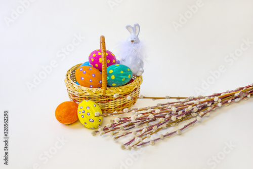 Easter eggs. Happy easter card. Multi-colored Easter eggs and rabbit. Easter eggs on a light background. Easter background. Easter eggs. Easter greetings. Happy easter. Willow. Copy space photo