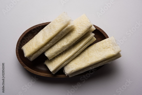 Pootharekulu  is a popular recipe originated from Andhra Pradesh, India.It is a paper-thin sweet or dessert made from rice start/gram flour, jaggery/sugar and clarified butter. Served in a plate. photo