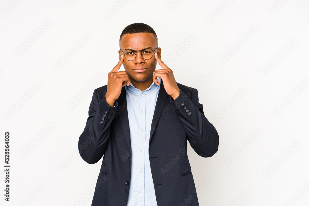 Young business latin man isolated on white background focused on a task, keeping forefingers pointing head. Young business latin man isolated on white background focused on a task, keeping forefingers pointing head.