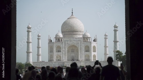 Taj Mahal with silhouettes of tourists visiting the mausoleum