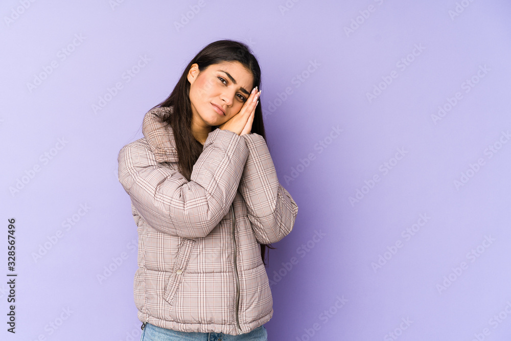 Young indian woman isolated on purple background yawning showing a tired gesture covering mouth with hand. Young indian woman isolated on purple background yawning showing a tired gesture covering mouth with hand.