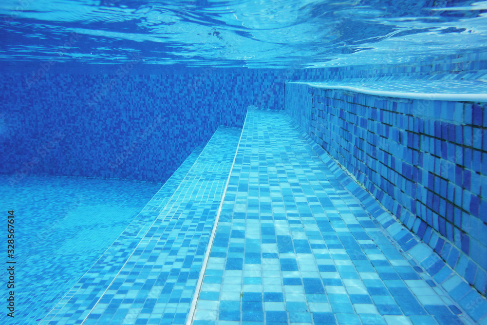 Underwater shot of stairs and tiles on pool bottom
