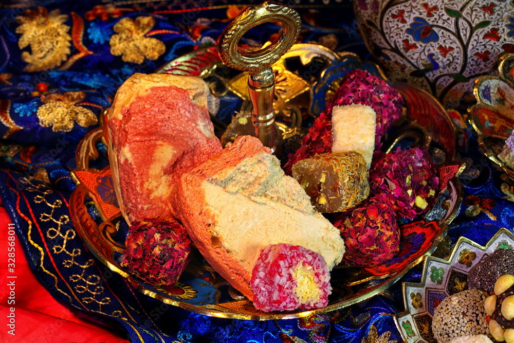 Oriental sweets on a red background in copper utensils Oriental sweets on a red background in copper utensils