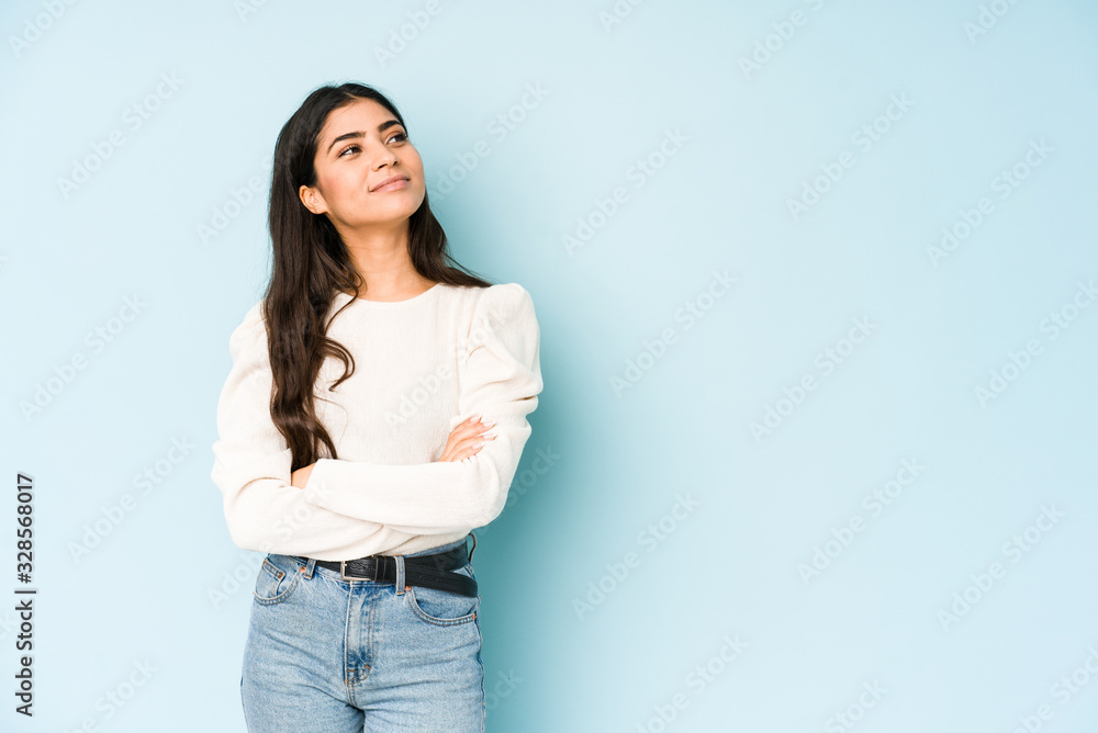 Young indian woman isolated on blue background dreaming of achieving goals and purposes Young indian woman isolated on blue background dreaming of achieving goals and purposes
