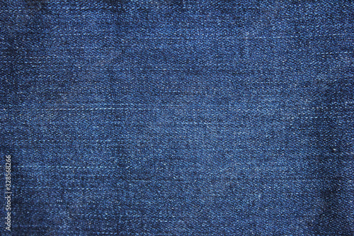 Denim jeans fabric background. Blue jean texture pattern, plain denim jeans material surface. Seamless dark denim cloth, blank fiber close up top view photo