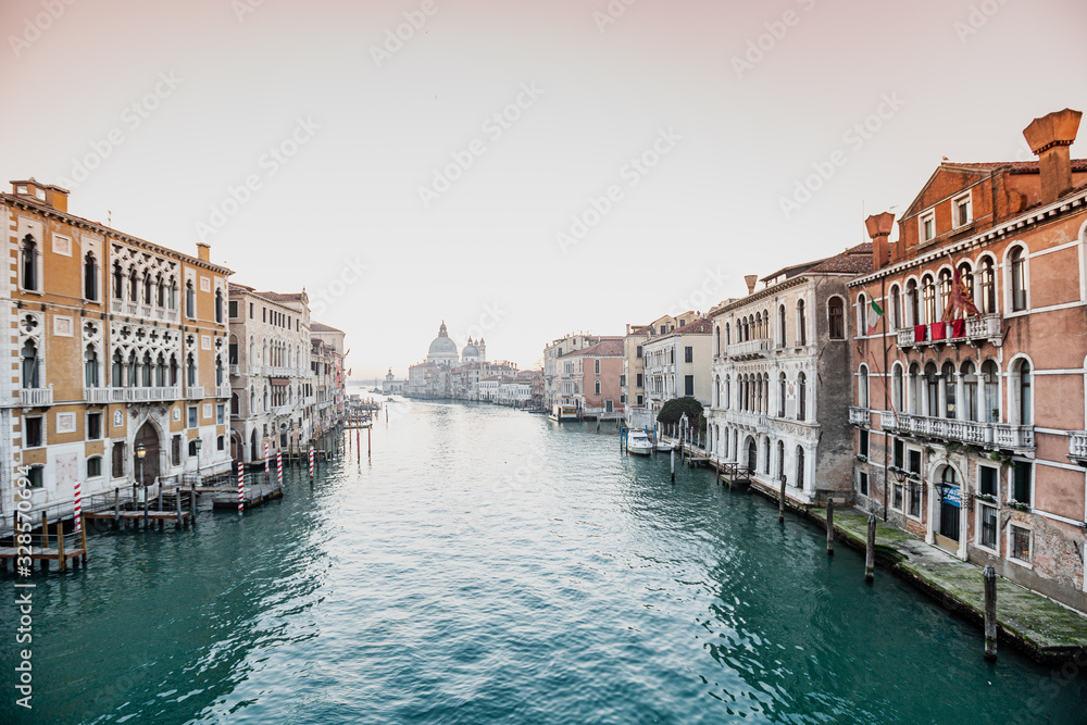 Naklejka premium canal in Venice, sunrise over the church