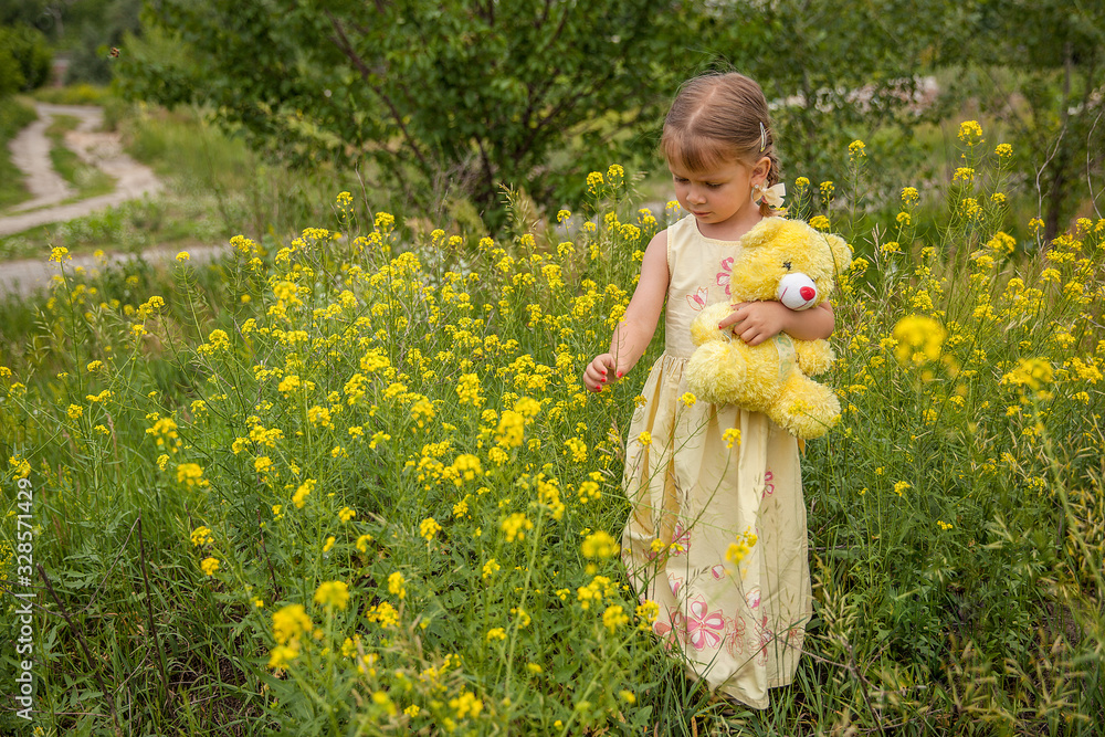 Portrait of a little cute girl with a teddy bear in her hands Portrait of a little cute girl with a teddy bear in her hands