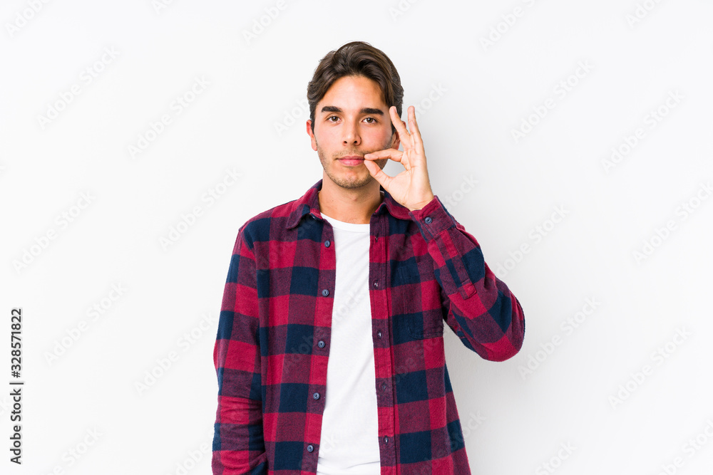 Young caucasian man posing in a pink background isolated with fingers on lips keeping a secret. Young caucasian man posing in a pink background isolated with fingers on lips keeping a secret.