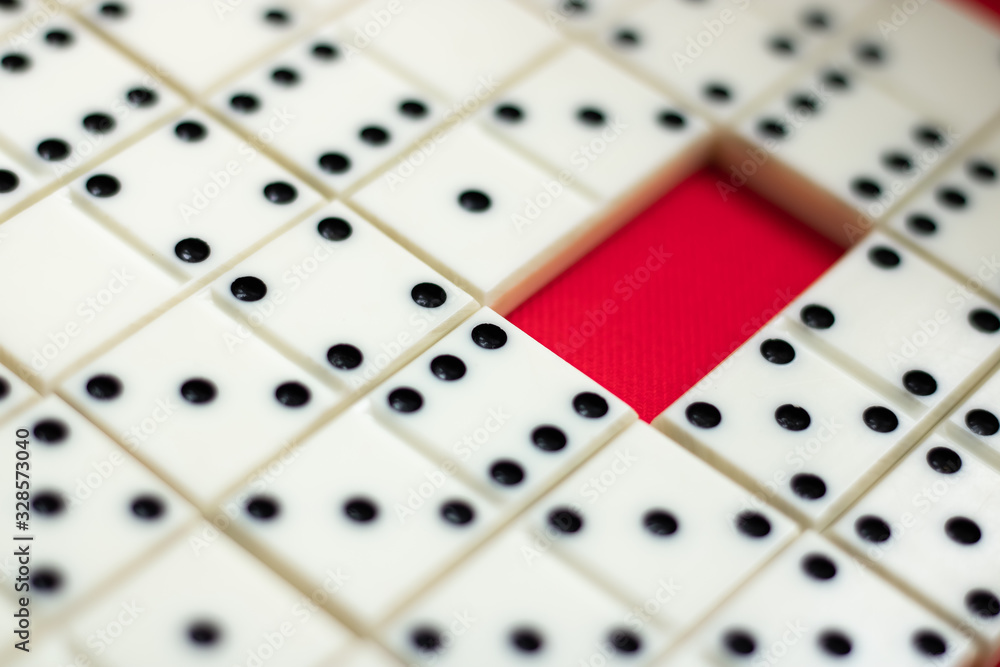 Dominoes The surface is lined with dominoes. Red free cell. Background. View from above Dominoes The surface is lined with dominoes. Red free cell. Background. View from above