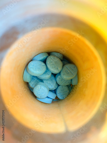 adderall adhd closeup 10mg blue pill addrl salts tablet prescription medication bottle addiction photo