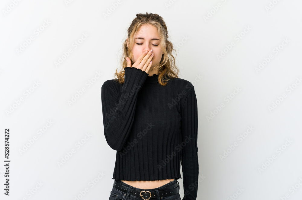 Young caucasian woman on white backrgound yawning showing a tired gesture covering mouth with hand. Young caucasian woman on white backrgound yawning showing a tired gesture covering mouth with hand.