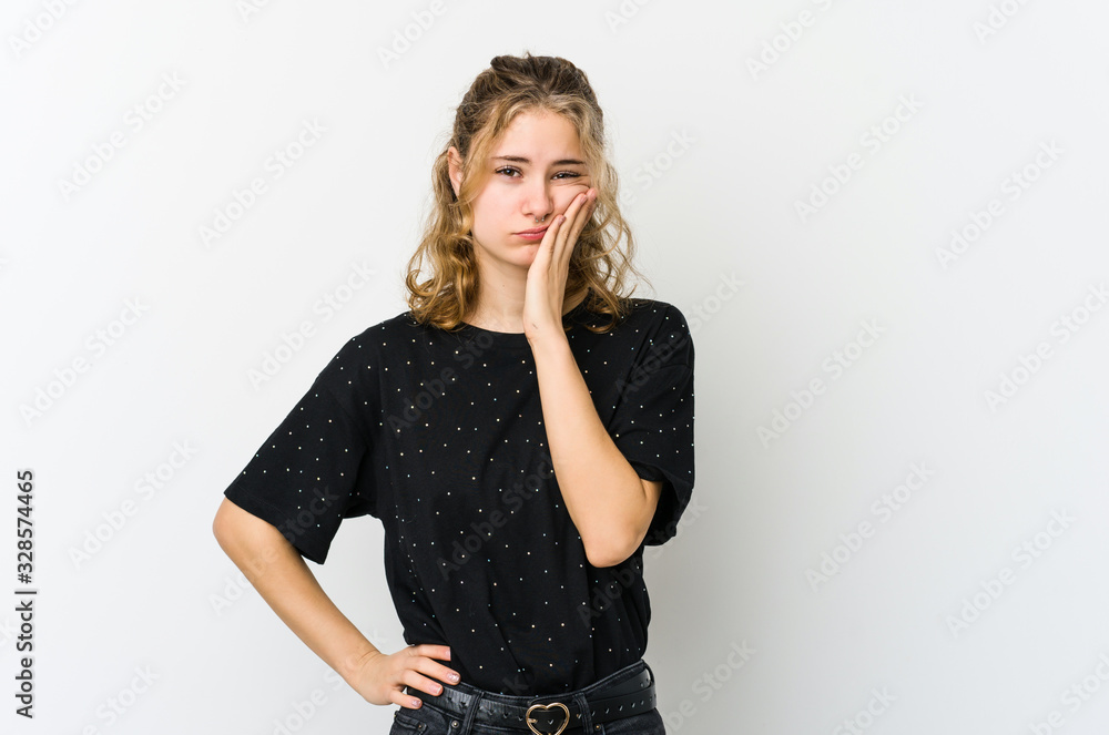Young caucasian woman on white backrgound who feels sad and pensive, looking at copy space. Young caucasian woman on white backrgound who feels sad and pensive, looking at copy space.