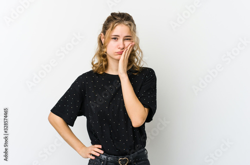 Young caucasian woman on white backrgound who feels sad and pensive, looking at copy space.