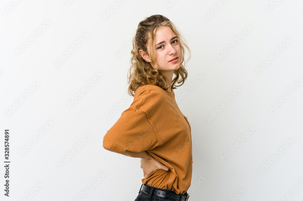 Young caucasian woman on white backrgound suffering a back pain. Young caucasian woman on white backrgound suffering a back pain.