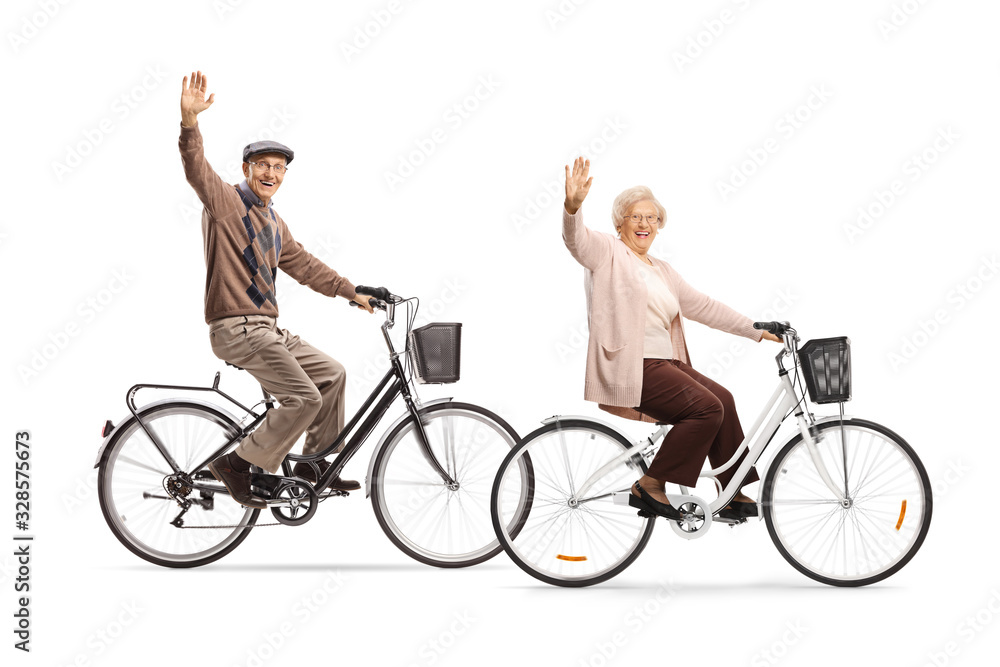 Seniors riding bicycles and waving at the camera Seniors riding bicycles and waving at the camera