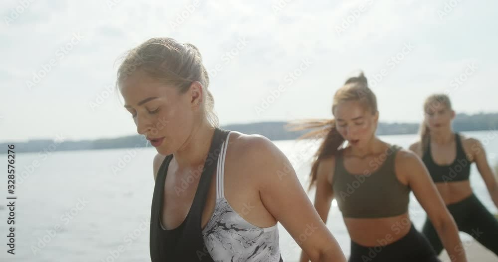 Female athletes exercising near water Female athletes exercising near water