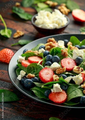 Spinach, Strawberry, blueberry salad with walnut and feta cheese. Summer healthy food