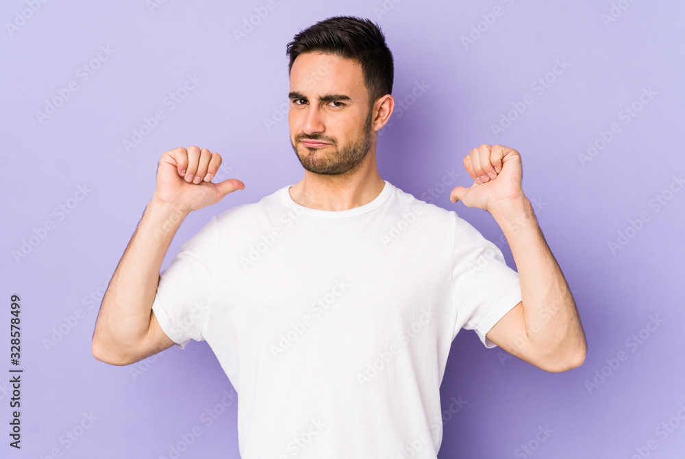 Young caucasian man isolated on purple background feels proud and self confident, example to follow. Young caucasian man isolated on purple background feels proud and self confident, example to follow.