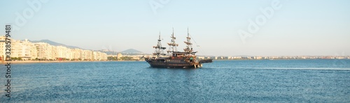 Old boat cruising in a blue sea,in a town in Greece Thessaloniki © lostintimeline