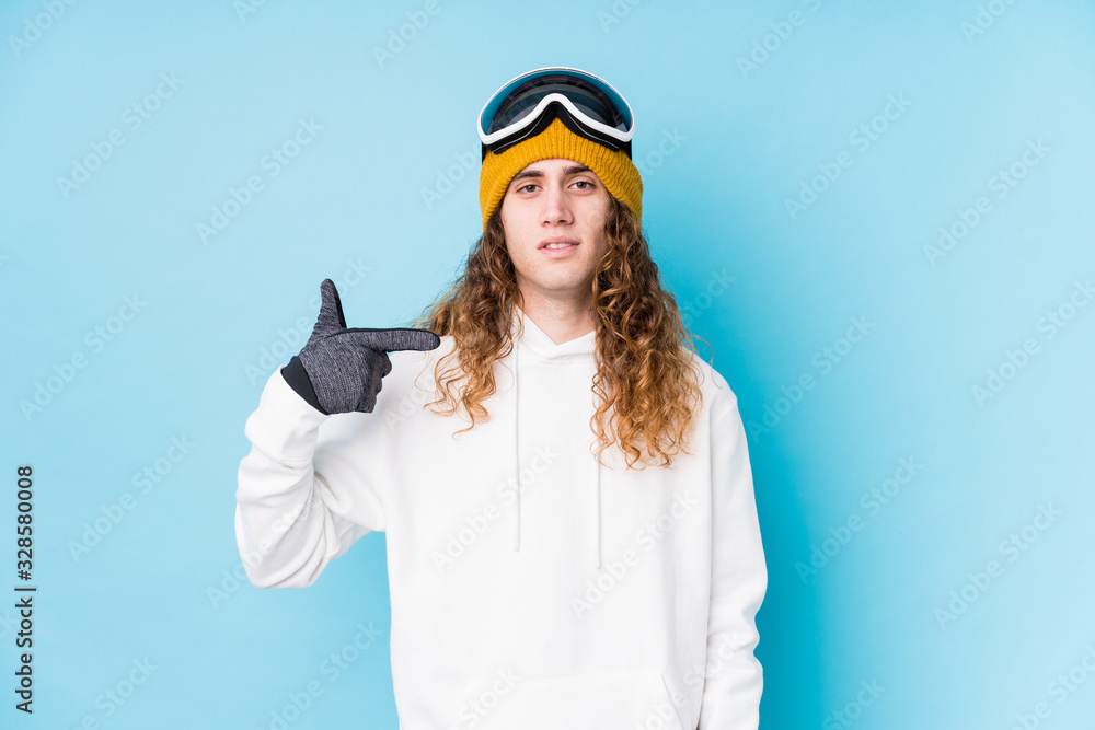 Young caucasian man wearing a ski clothes isolated person pointing by hand to a shirt copy space, proud and confident Young caucasian man wearing a ski clothes isolated person pointing by hand to a shirt copy space, proud and confident