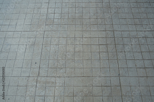 gray concrete ground at walk way. square pattern footpath.