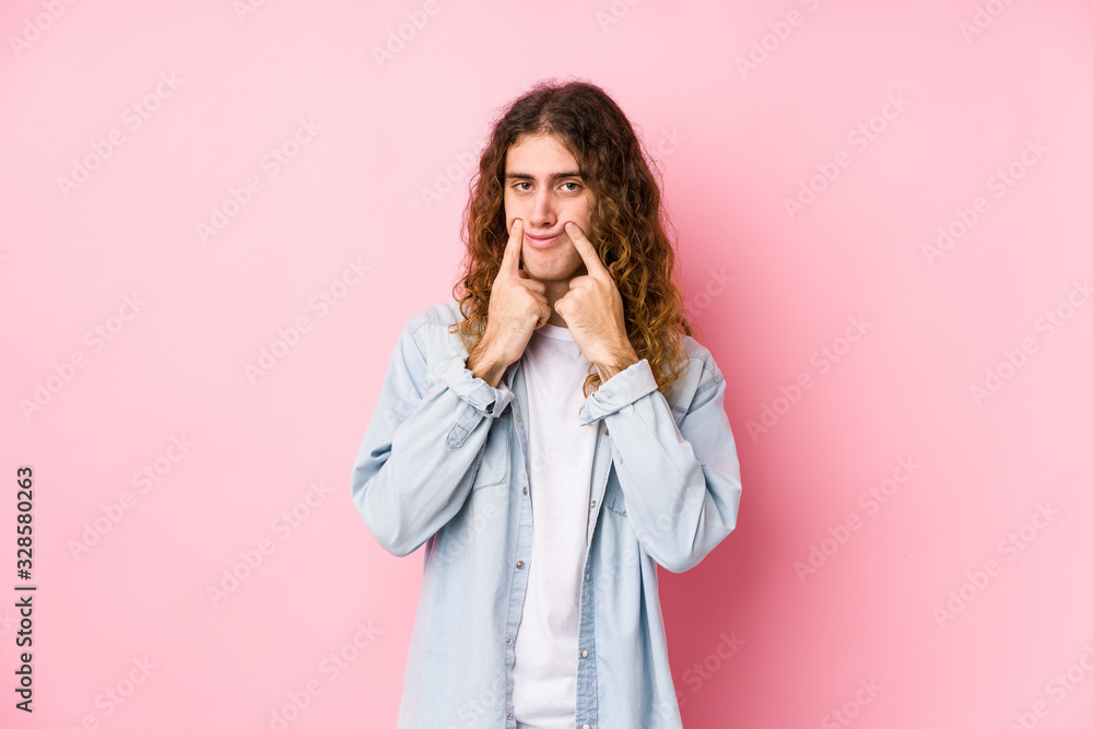 Long hair man posing isolated doubting between two options. Long hair man posing isolated doubting between two options.
