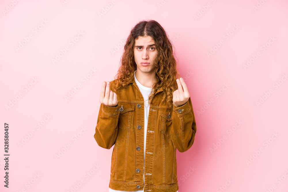Young long hair man posing isolated showing that she has no money. Young long hair man posing isolated showing that she has no money.