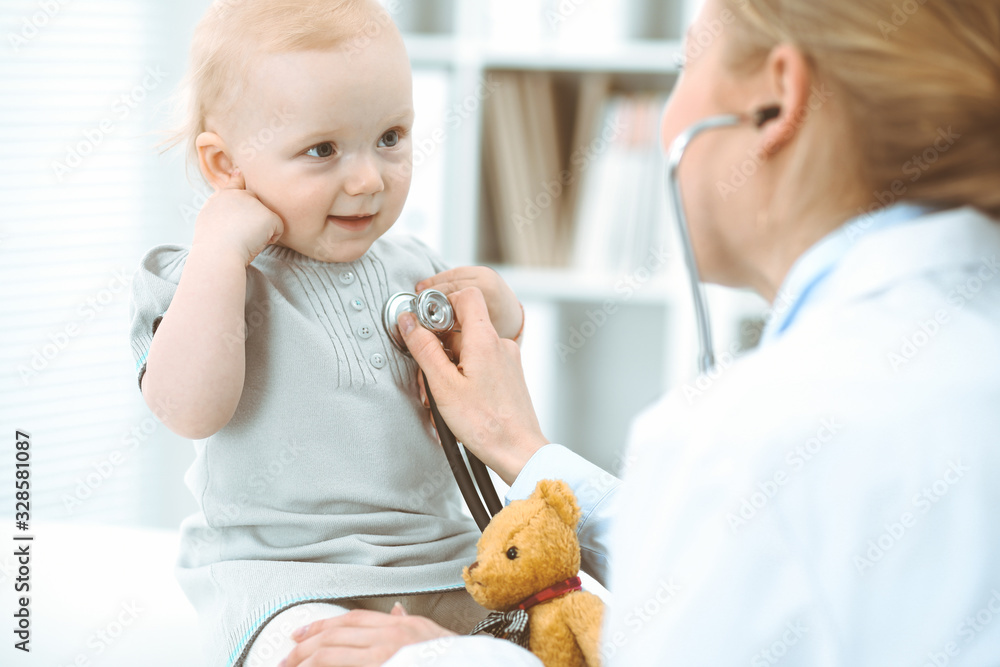 Doctor and patient in hospital. Little girl is being examined by doctor with stethoscope. Medicine concept Doctor and patient in hospital. Little girl is being examined by doctor with stethoscope. Medicine concept