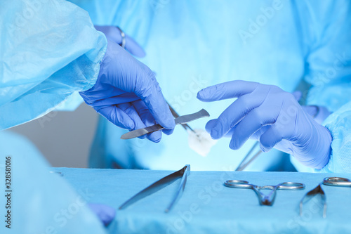 Close-up of medical team performing operation. Group of surgeons at work are busy of patient. Medicine, veterinary or healthcare and emergency in hospital