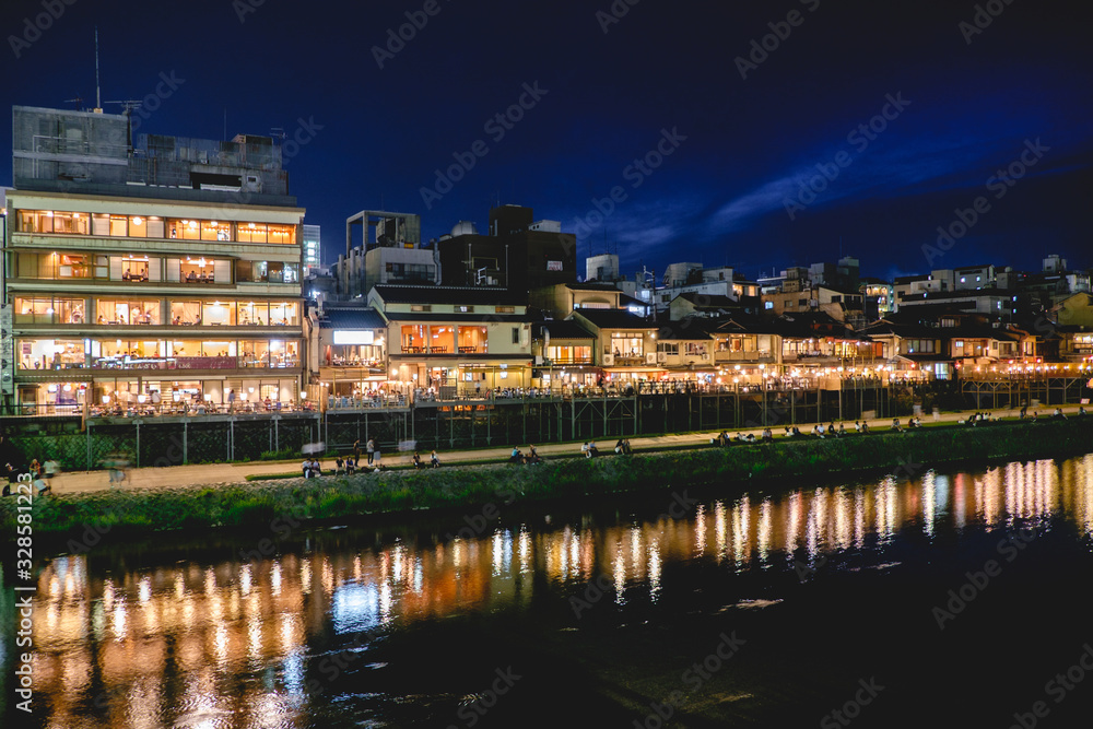 Obraz premium Traditional restaurants and Kamo River reflections at night, Kyoto, Japan