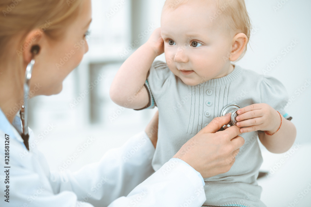 Doctor and patient in hospital. Little girl is being examined by doctor with stethoscope. Medicine concept Doctor and patient in hospital. Little girl is being examined by doctor with stethoscope. Medicine concept