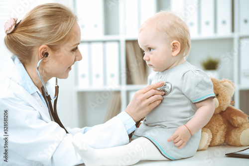 Doctor and patient in hospital. Little girl is being examined by doctor with stethoscope. Medicine concept