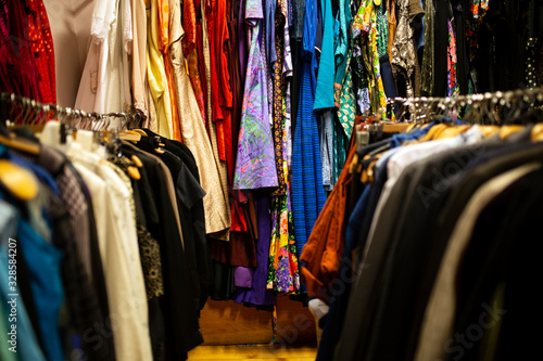 Different clothes on the stand. Fashion swap, second hand, slow fashion. Close up on used clothes. 