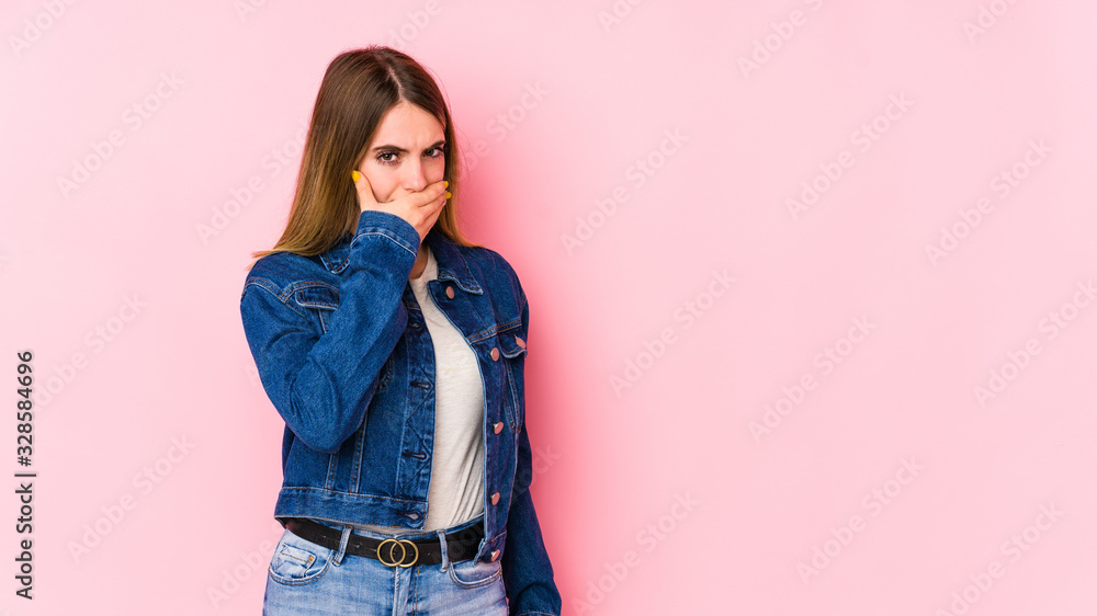 Young caucasian woman isolated on pink background covering mouth with hands looking worried. Young caucasian woman isolated on pink background covering mouth with hands looking worried.