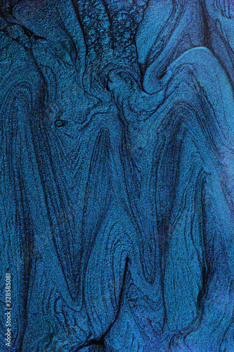 Vertical abstract banner with liquid nail polish texture.Navy blue.Negative space for text or design.Beautiful stains of liquid nail polish,fluid art technique.Marble background.