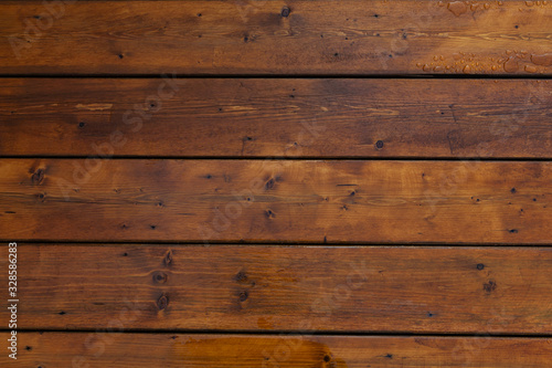 Stained wet deck wooden boards with water drops texture