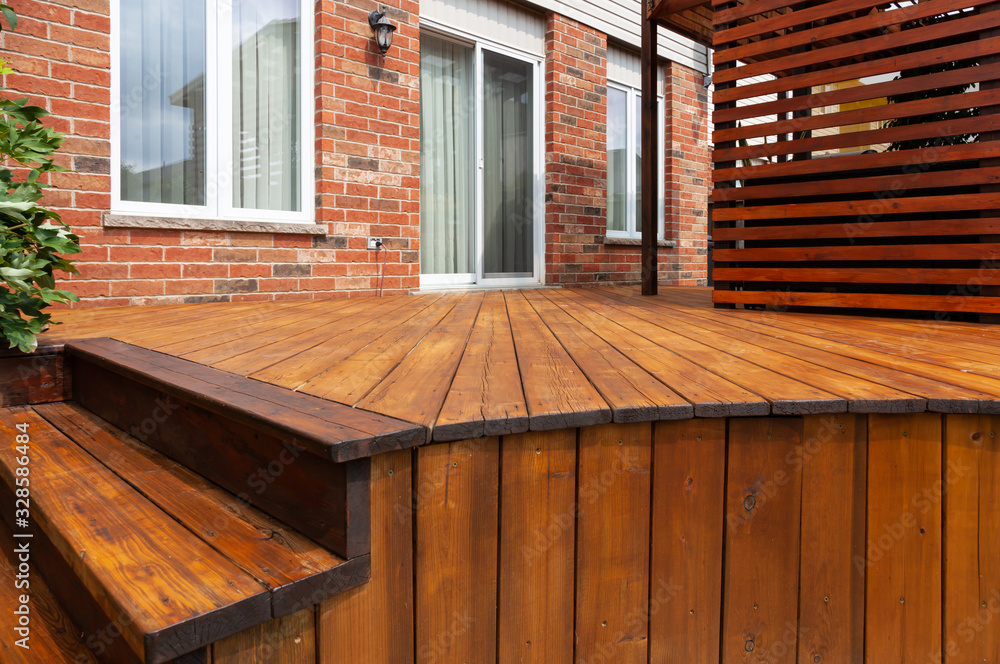Backyard wooden deck floor boards with fresh brown stain - obrazy, fototapety, plakaty 