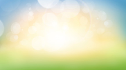 A fresh spring, summer sunny blue sky background with blurred warm bokeh glow.