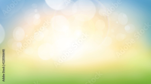 A fresh spring, summer sunny blue sky background with blurred warm bokeh glow.